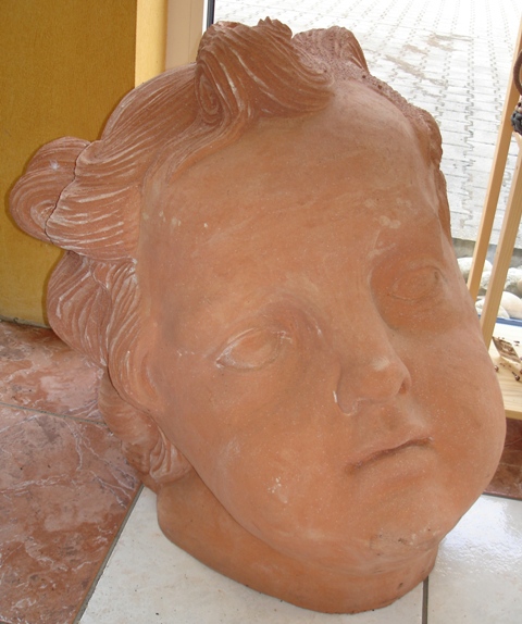 Terrakotta Puttenkopf - zum Schlieen ins Bild klicken